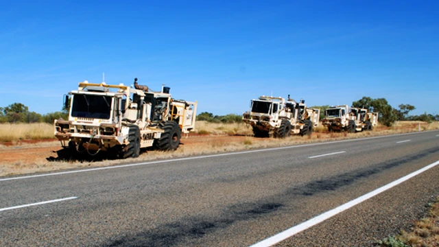 Vibroseis trucks alongside the Barkly Highway, Queensland, working on the South Nicholson Basin seismic line.