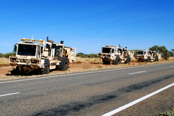 Vibroseis trucks alongside the Barkly Highway, Queensland, working on the South Nicholson Basin seismic line.
